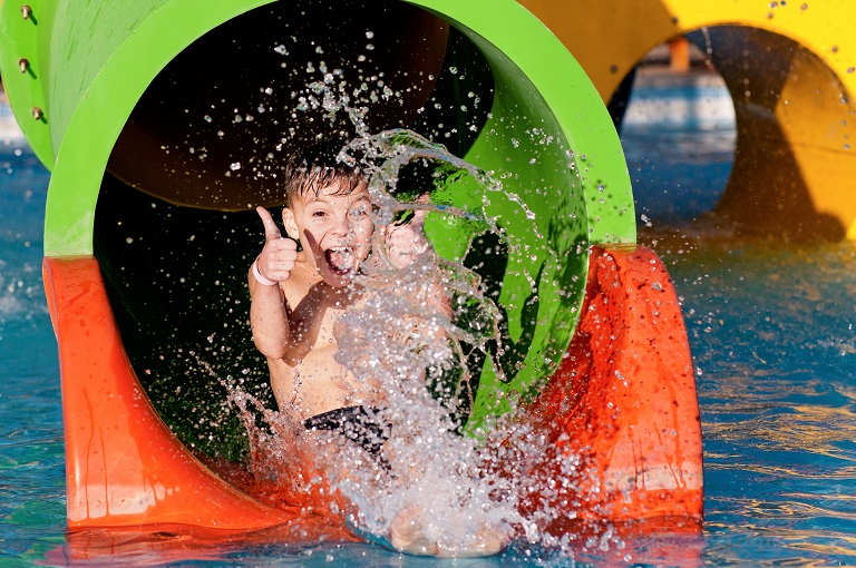 Pools with water slides: reasons to install them and design tips